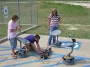 Court Sullivan, KF5HYE, James Boshart and Jake Rhodes, KF5HYD, complete
the calibration process on three radio-telescope units in preparation for an
interferometry research project in which the three units will be interconnected
to simulate a much larger dish. [Larry D. Barr, K5WLF, Photo]
